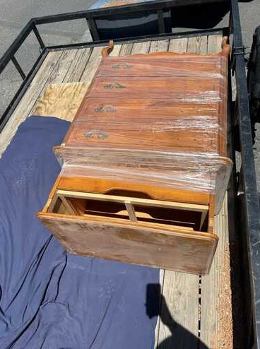 Wooden furniture loaded in a hauling trailer